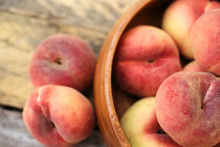 Whole peaches in a cup which is part of the best way to freeze peaches