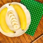 2 bananas and some slices of them on a plate which can be part of the best way to freeze bananas