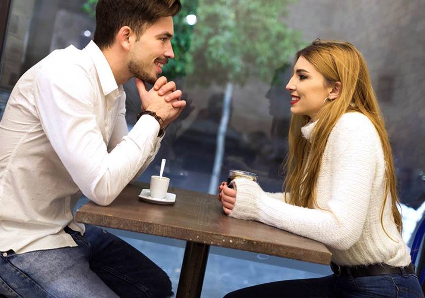 A man talks to a woman using the best way to meet woman in a coffee