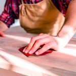 A man performs the best way to remove paint from wood