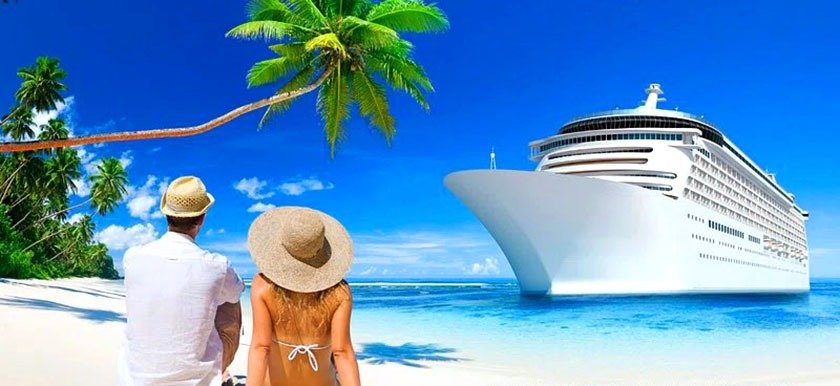 A couple on the beach looking at the cruise ship that was part of the process of the best way to book a cruise