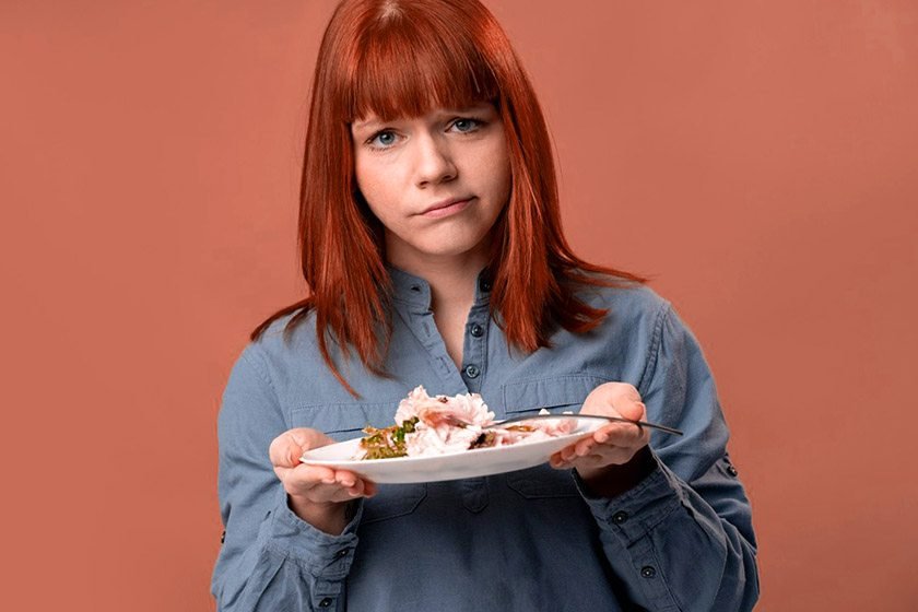 A woman is holding a plate and is practicing the best way to break a fast