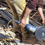 A man performs the best way to cut rebar