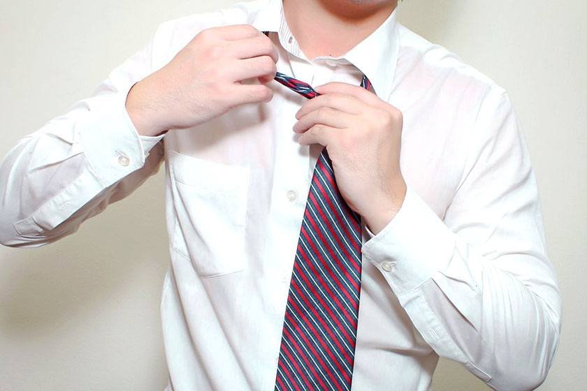 A man is preparing to use the best way to store ties