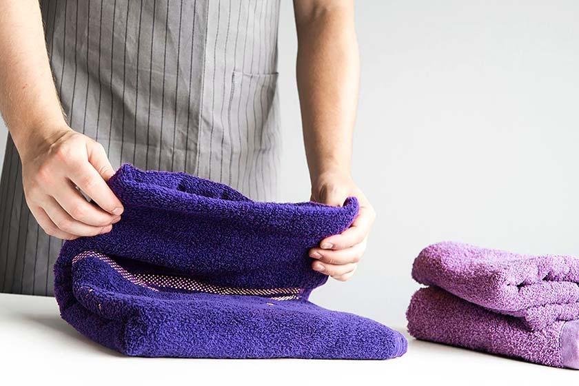 A man performs the best way to fold towels