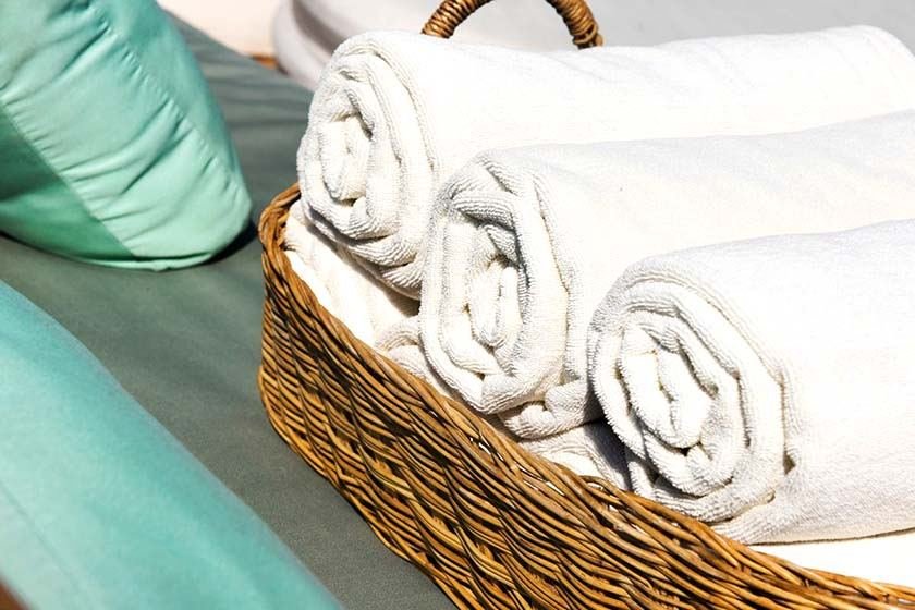 Rolled towels in a wicker basket