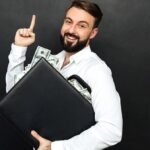 A man holds a briefcase of money, which may be the best way to invest 50k