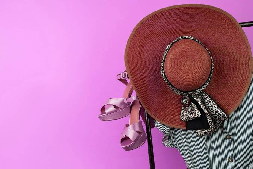 A hat rack with heels, a blouse and a hat