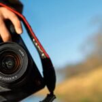 A hand holds a camera that is the hour of action behind the best way to store photos