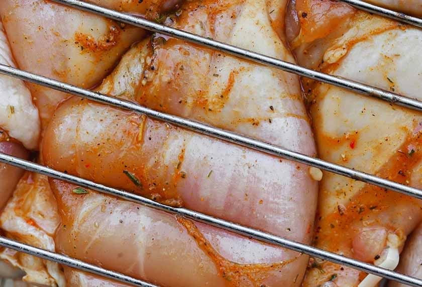 Fresh chicken is drained with a wire rack