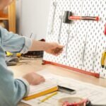 A man performs the best way to organize tools on a pegboard