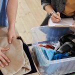 A couple performs the best way to pack clothes for moving