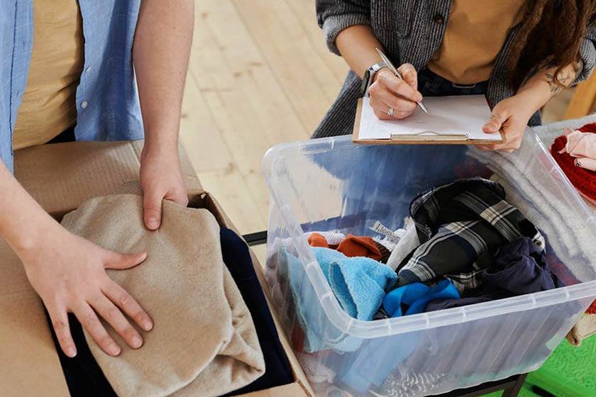 A couple performs the best way to pack clothes for moving