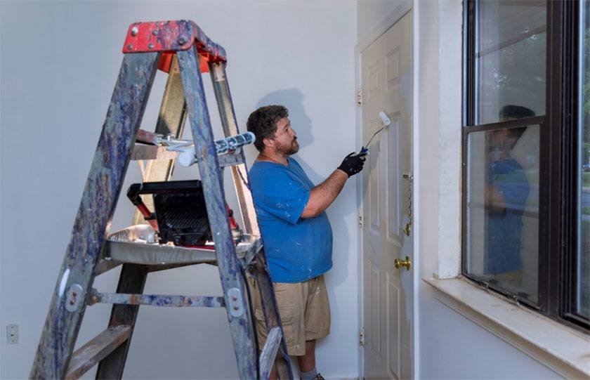 A man performs the best way to paint a door in his house