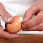 A man performs the best way to peel boiled eggs