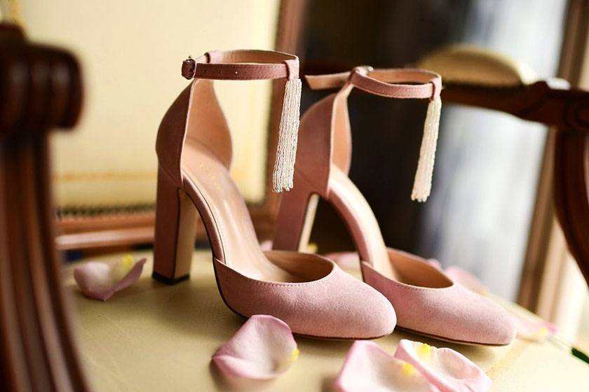 A pink high heels on the ground 