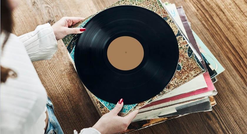 A woman performs the best way to store vinyl records